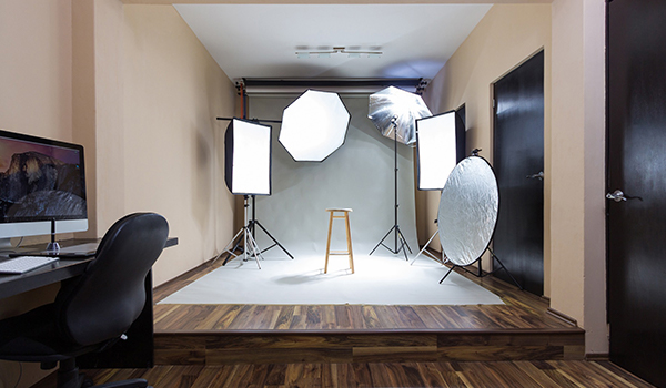 Photography studio equipment includes lighting backdrop and a computer
